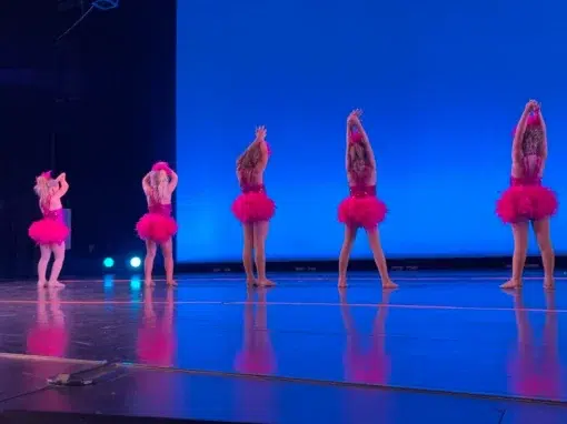 Encore Five Dancers Pose on Stage Performance Five dancers in their pink costumes performing on stage